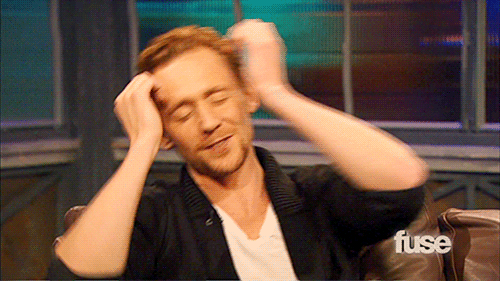 Tom Hiddleston hiding in embarrassment
